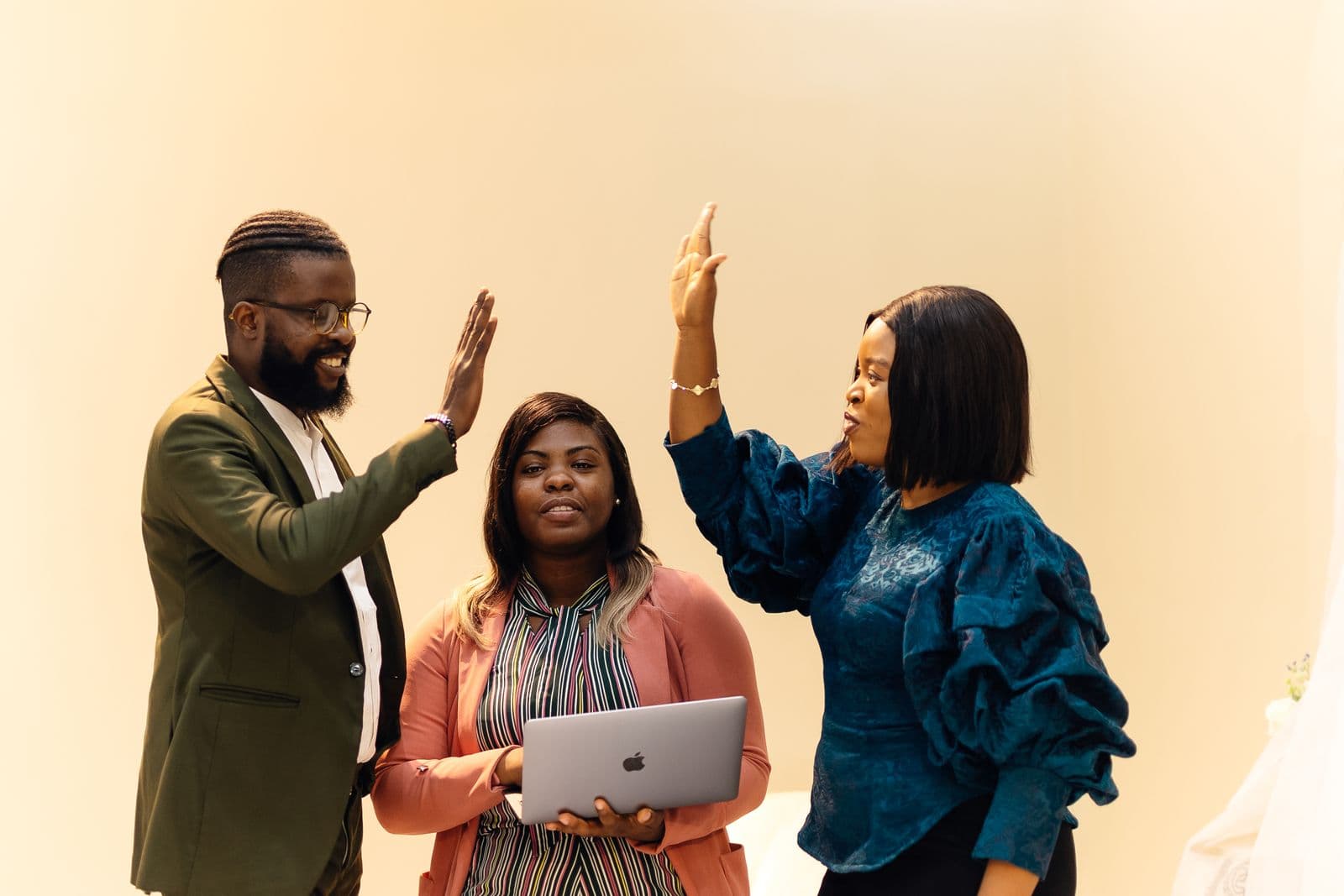 A team in Lagos celebrating with a high five