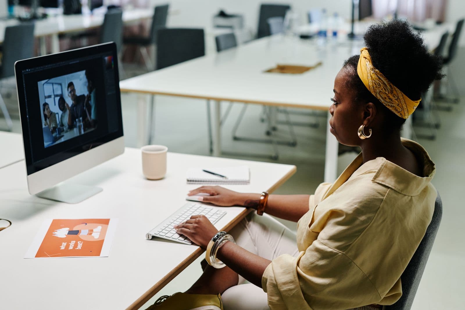 A designer working on visuals at her desktop computer